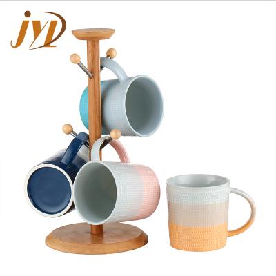 China Viable Unique Gradient Color Design Ceramic Embossed Cup Mug With Wooden Lid for sale