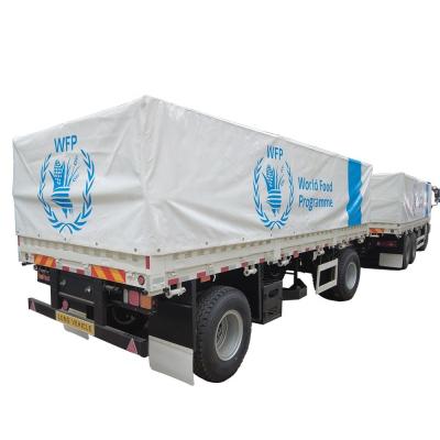 China Cereal Transport 60T Flatbed Trailer Train with Mechanical Suspension and Tarpaulin for sale