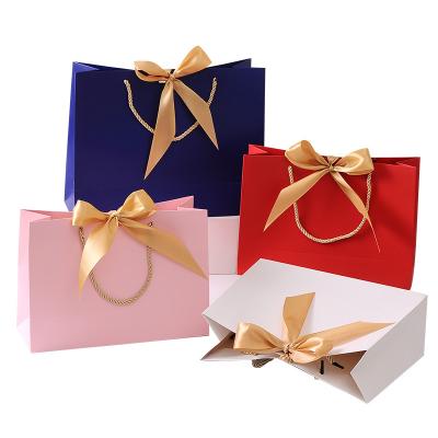 China Luxury Strong Paper Gift Bags Shopping Packaging Bag With Ribbon Handles for sale