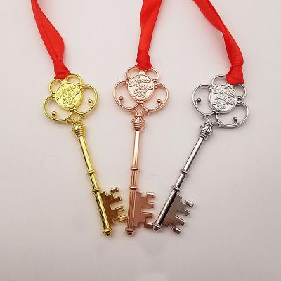 China Stock Variety Shiny Antique Plating Metal Promotional Gifts Magic Santa Key With Red Ribbon For Christmas for sale