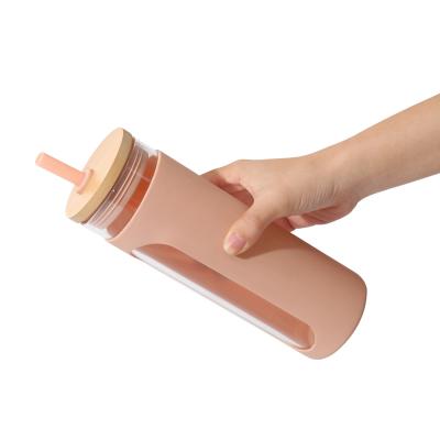 China Large Capacity Viable Portable Single Glass Outer Juice Sleeve Silicone Mikenda Glass Water Bottle With Wooden Lid for sale