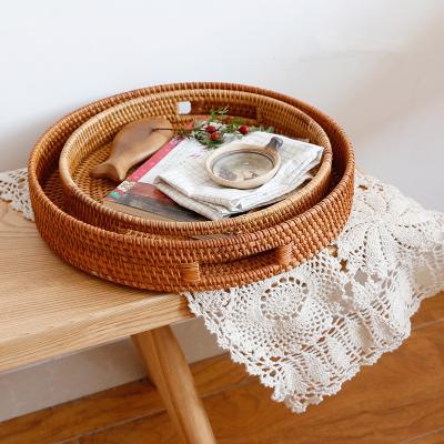 China Handmade Nordic Northern Europe Huangtu Sustainable Rattan Basket With Handles Wicker Woven Handcraft Storage Serving Tray for sale