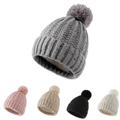 China COMMON Custom Thick Jacquard Single Pompom Knitted Furry Coating Winter Beanie Hat for sale