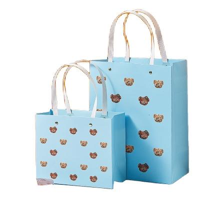 China Wholesale Biodegradable Small Bear Pattern Cardboard Packaging Gift Exquisite White Paper Bag For Gift for sale