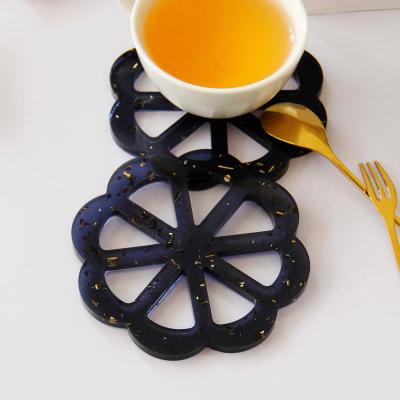 China Creative Simple Black Hollow Flower Shaped Cup Mat European Style Cup Holder Resin Coaster Mat for sale