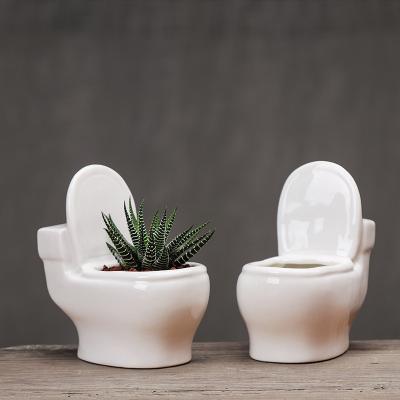 China Creative Funny Cartoon Toilet Shape Mini Ceramic Flowerpot Home Decoration Ceramic Flower Pots and Planters for sale