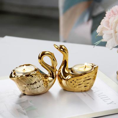 China Newly swan decoration ceramic candle holder luxury gold ceramic luxury candlestick home decoration for sale