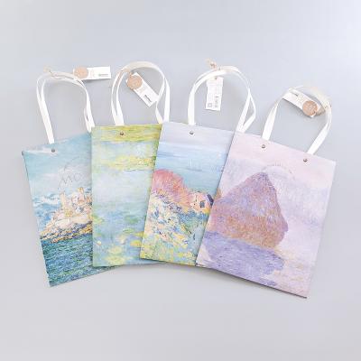 China Recyclable Elegant New Design Large Size Flower Ribbon Handle White Packaging Paper Bag For Gift Shop for sale