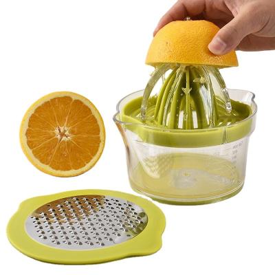 China Viable Wholesale Kitchen Instrument 4 in 1 Multifunctional Manual Fruit Juicer with Grater and Container for sale