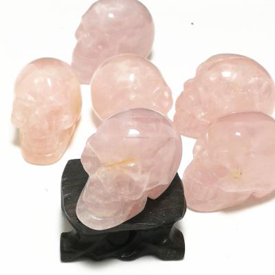 China China Hand Carved Polished Natural Crystal Skulls Rose Quartz Skulls Smiling Skulls Healing Stones for sale