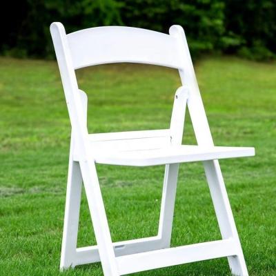 China Modern White Resin Event Wedding Padded Plastic Folding Chair for sale