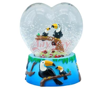 China Zoo Souvenir Animal World Parrot Figurine Heart Shape Water Snow Globe for sale