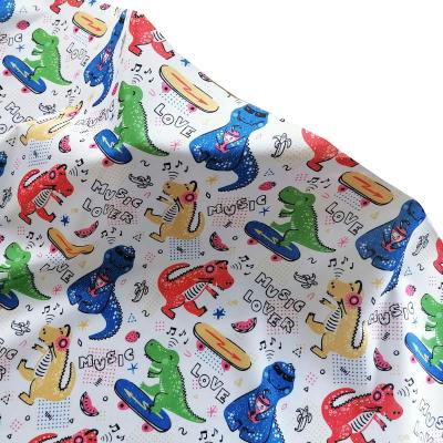 China Wicking Cartoon Dinosaur Print Polyester Flat Surface High Quality Material Fabric For Shirt for sale