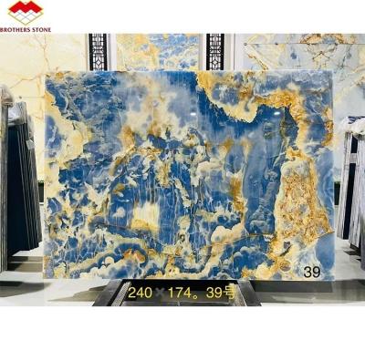 China Blue Golden Onyx Stone Slabs Natural Translucent Marble for TV Background Wall Panels for sale