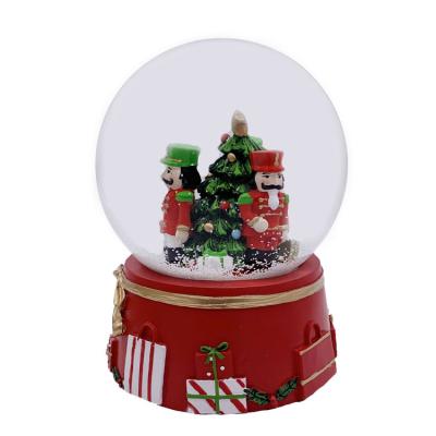 China Worldwide newcomer christmas 2021 musical nutcracker and trees snow globe with gift box background for sale