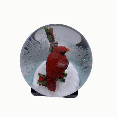 China Worldwide 100MM Resin Snow Globe For Christmas Gifts Glass Hand Painted Cardinal Snow Globe for sale