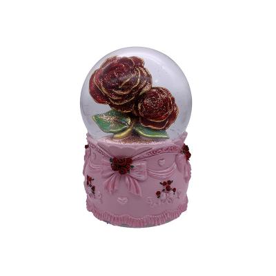 China Worldwide Blowing Rose Musical 100MM LED Snow Rose Water Globe for sale