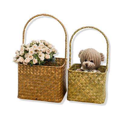 China Straw Material Natural Flower Baskets Friendly Home Decoration Eco Rattan Fruit Basket Sea Viable Storage Basket Flower Handles for sale