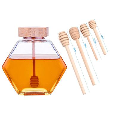 China Eco-friendly biodegradable disposable wooden stick-1 piece small hexagon glass honey 100ml wholesale jar with wooden plunger for sale