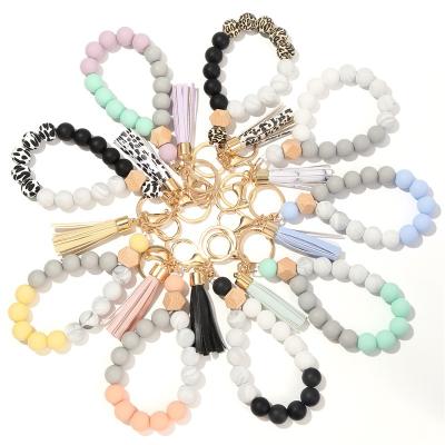 China Women Modern Unique Elegant Beaded Bracelet Wristlet Leather Tassel Ring Key Silicone Key Chain for sale