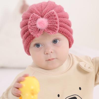 China JOINT European and American Woolen Children Knit Ball Infant Hood Hat Solid Color Warm Bowknot Fur Hat for sale