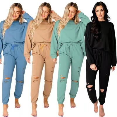 China 2022 Cotton Sustainable Women's Tracksuit Spring And Autumn Ripped Cutout Casual Jogging Two Piece Sweatsuit Fashion for sale