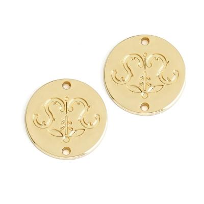 China Viable Custom Circle Metal Sewing Labels, Metal Engraved Logo Plate for Clothing, Gold Plated Metal Sewing Label for Garment Swimwear for sale