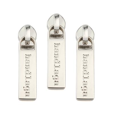 China Custom Logo Nickel Free Engraved Custom Logo Zipper Puller Tabs Metal Zipper Puller Sliders Logo Zipper Pull Head for sale