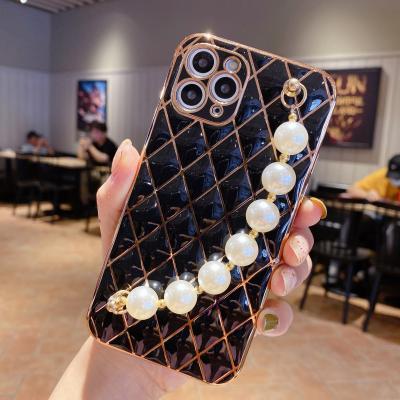 China Shockproof High Quality Pearl Wrist Chain Leather Phone Cases For iPhone 12 Cell Phone Leather Covers With Pearl for sale