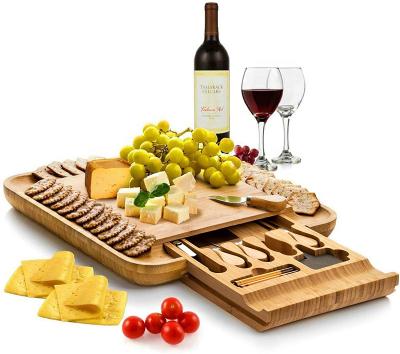 China Sustainable Bamboo Cheese Board and Cutlery Set - Wooden Serving Tray with Slide Hidden Drawer - and Wide Juice Groves for sale