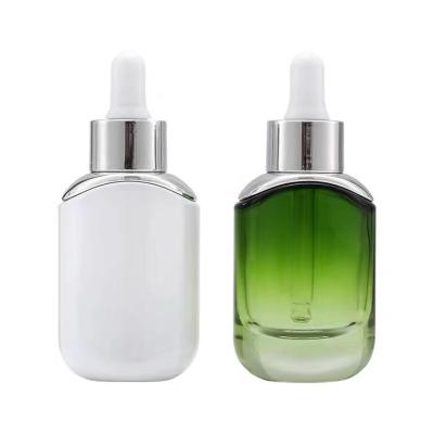 China Eco-friendly Packaging Small Hair Oil Glass Bottle 30ml Customized Dropper Bottle Green Clear Flat Empty Glass Essential Oil Bottle for sale