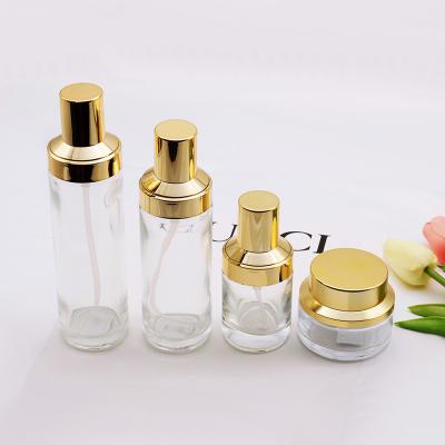 China Eco-friendly 40ml 50ml luxury clear glass cream jar and facial cosmetic lotion cream bottle set with gold lid for sale