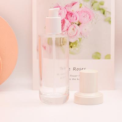 China Eco-friendly Empty Luxury Transparent Round Cosmetic Lotion Glass Bottle With Pump for sale