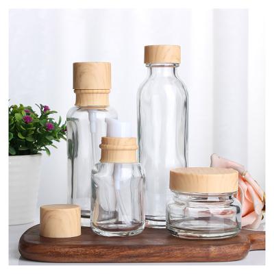 China Single Clear Cosmetic Glass Empty Round Toner Bottle Eco-friendly Bottle 30ml 100ml With Screw Cap for sale