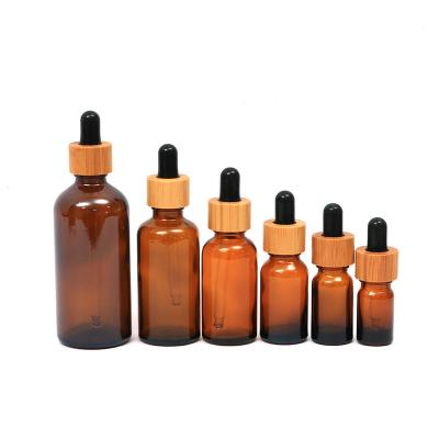 China Custom Eco-Friendly Brands Tan Screen Printing Dropper Bottle 5ml 30ml Brown Empty Glass Essential Oil Bottle With Bamboo Lid Dropper for sale