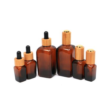 China OEM Eco-friendly 1oz 30ml High Quality Square Liquid Dropper Bottle With Lid Amber Glass Essential Oil Bottle Bamboo Dropper Empty for sale