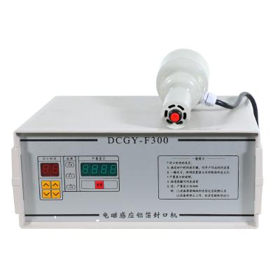 China Food Aluminum Foil Cans Knock Induction Heat Sealing Plastic Bottle Sealer Electromagnetic Induction Sealing Capping Machine for sale