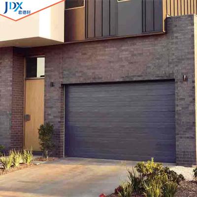 China Modern Bulletproof Wpc Rolling Garage Doors Store Residential Garage Black Automatic Sectional Steel Doors High Wind for sale