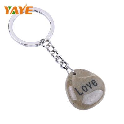 China Europe factory supply natural river stone customized design engraved key chain for gifts for sale