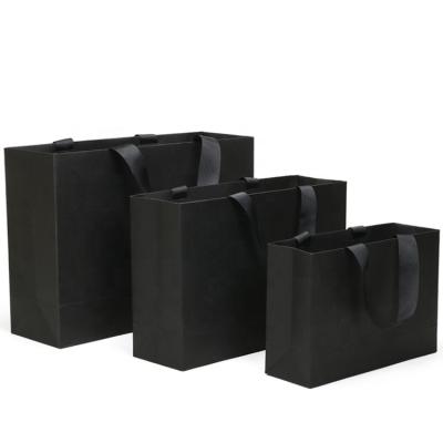 China Recycled Materials New Arrival Business Retail Wrapping Bag Personalized Logo Custom Black Gift Bags With Ribbon for sale