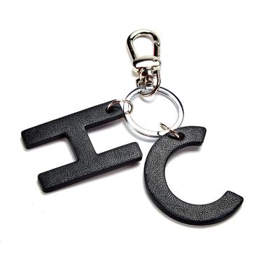 China Fashion Brand Lettering Liquid Car Bag Charm Key Chain Sequin Quicksand Dangling Key Chain For Women Men Kids for sale