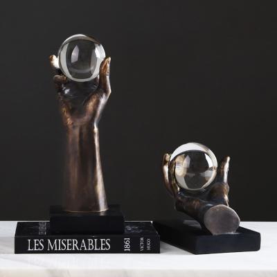 China Modern Nordic Luxury Sculpture Home Decor Resin Hand Sculpture With Crystal Ball for sale