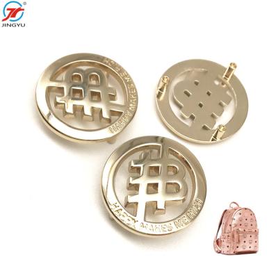 China Viable Custom Embossed Logo Gold Brand Name Clothing Handbag Metal Label Round Label Tags for sale