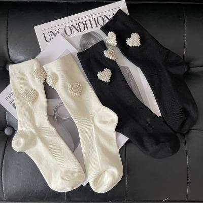 China Cute Black And White Solid Color Sporty Pearl Heart Women's Socks Tube Socks for sale