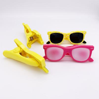 China Custom Sand/Beach/Pool Cartoon Children's Sunglasses in Various Colors Beach Towel Clip for sale