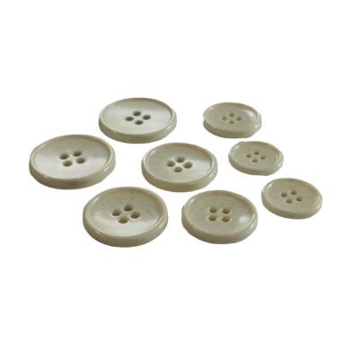 China Sustainable Hot Sale Quality Eco Friendly Urea Plastic Milky White Color Four Holes Button for sale