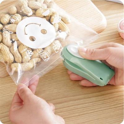 China Food Household Food Saver Packing Sealing Machine Powder Painted Steel Portable Mini Food Storage Bag Sealer for sale