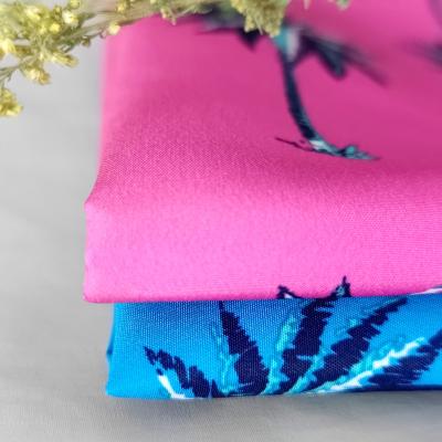 China Hawaii summer vacation waterproof coconut tree leaves beach printing fabric for kids wear beach shorts for sale