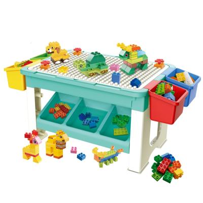 China Building Toy Multifunctional DIY Large Particles Building Bricks 69pcs With Storage Box Kids Blocks Play Table Learn Desk for sale