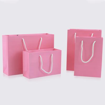 China Recyclable Pink Paper Bag Gift Apparel Gift Packaging Shopping Bag Belt Support Printing 1 Color Simple Logo for sale